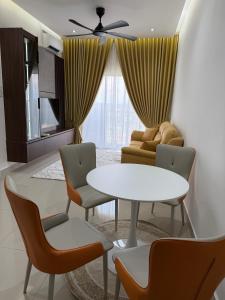 a living room with a table and chairs and a couch at Sufi Islamic Homestay for Islamic only in Nilai