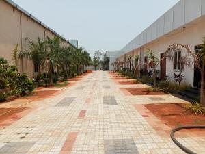 an empty street in front of a building at Mega Grand Rooms in Narasaraopet