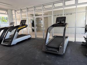 a gym with two treadmill machines in front of a building at Sufi Islamic Homestay for Islamic only in Nilai