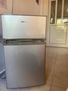 a refrigerator in a kitchen with a door open at Two Palm Trees 1 in Adamantas