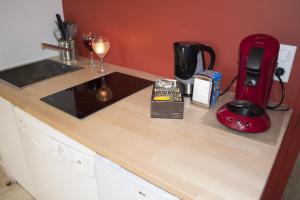 a kitchen counter with a sink and a blender at Appartement12.com in Charleville-Mézières