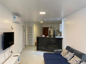 a living room with a couch and a flat screen tv at Vista mar nascente in São Luís