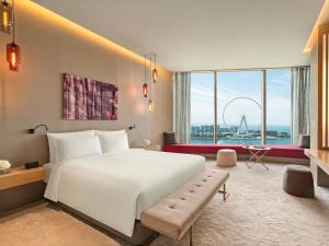a bedroom with a large white bed and a large window at Rixos Premium Dubai JBR in Dubai