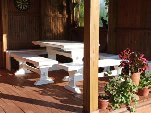 a white picnic table and benches on a porch at BALTĀ māja in Aglona