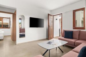 a living room with a couch and a table at The Dandy Family Apartments in Syvota