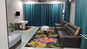 a living room with a couch and a rug at Roomstay Ust Omar in Tumpat +12 photos