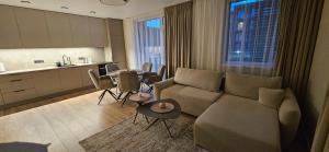 a living room with a couch and a table at Karaliauciaus Apartment in Vilnius