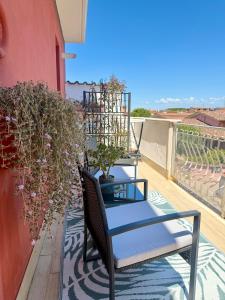 a chair on a balcony with a plant at Katrina's Home alloggio turistico in Fiumicino