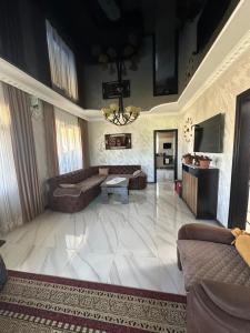 a large living room with a couch and a table at mado house in Chakvi