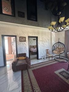 a living room with a couch and a mirror at mado house in Chakvi