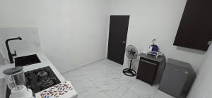 a kitchen with a stove and a counter top at Departamentos De Cadereyta in Cadereyta Jiménez