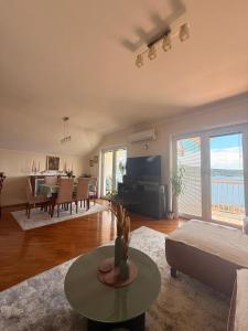 a living room with a couch and a living room with a table at Lovely duplex apartment in Savina