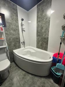 a bathroom with a bath tub and a toilet at mado house in Chakvi