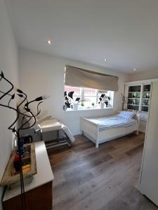 a bedroom with a bed and a window at Villa shared Fieldsight Doornspijk - a shared villa no breakfast in Doornspijk