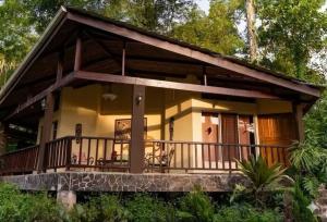 a small house with a large balcony at Heliconia Island Lodge in Puerto Viejo