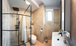a bathroom with a shower and a toilet and a sink at Bucovina Comfort Apartament in Gura Humorului +11 photos