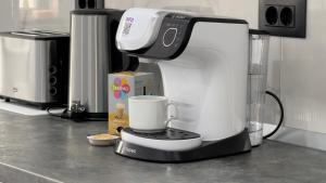 a coffee maker sitting on top of a kitchen counter at Bucovina Comfort Apartament in Gura Humorului