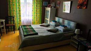 a bedroom with a bed with two pillows on it at BALTĀ māja in Aglona