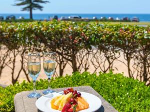 a plate of food and two glasses of wine at ibis Styles Port Macquarie in Port Macquarie