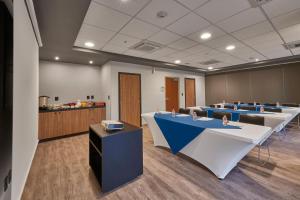 a conference room with tables and chairs and a counter at City Express Plus by Marriott Cali Colombia in Cali