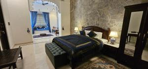 a bedroom with a king sized bed and a window at Barabagh Deogarh - A Heritage Farm Stay in Devgarh +85 photos