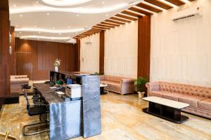 a lobby with a reception desk and a couch at HOTEL DHAROHAR in Pura Raghunāth