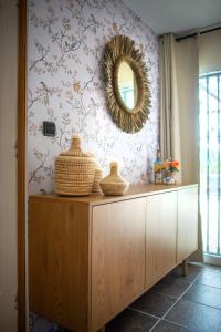 a mirror on a wall above a dresser in a room at Casa Carla Andalucia, el Torcal in Almogía
