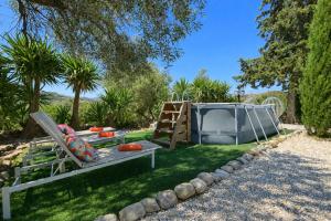 a garden with a swing and a playground at Casa Carla Andalucia, el Torcal in Almogía