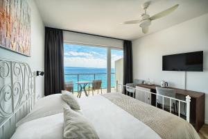 a bedroom with a bed and a view of the ocean at STELLA'S BEACHFRONT - Aparthotel - FREE PARKING in Split