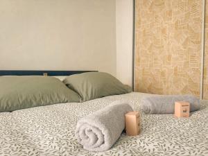 a bedroom with a bed with a pillow and two speakers at The globe trotter - Perpignan in Perpignan