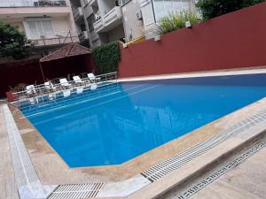 a large blue swimming pool in a building at Luxor apartments in Alanya