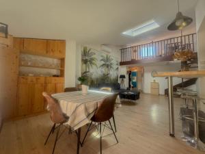 a living room with a table and some chairs at The globe trotter - Perpignan in Perpignan