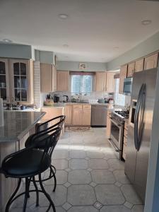 a kitchen with a refrigerator and two chairs in it at Seascape in Haven Beach