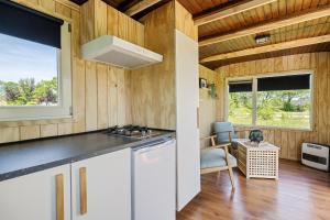 a kitchen with a sink and a stove in a room at Camping de Wartenster - De Pipowagen in Wartena