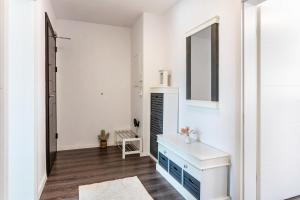 a white room with a blue dresser and a mirror at Haus Gera in Gera +68 photos