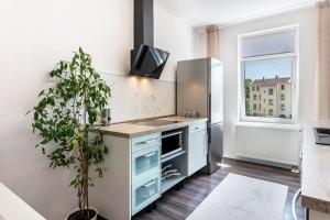 a kitchen with a stainless steel refrigerator and a potted plant at Haus Gera in Gera
