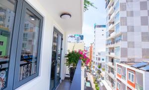 a balcony with a plant on a building at Berlin Haus Nha Trang Hotel in Nha Trang