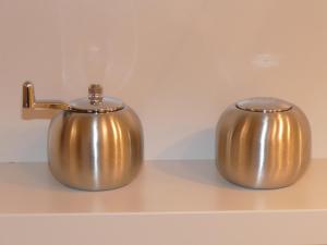 two metal tea pots sitting on a shelf at Chads City Apartment mit Tiefgarage free parking in Graz