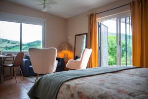 a bedroom with a bed and a table and chairs at Casa Carla Andalucia, el Torcal in Almogía