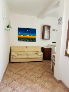 a living room with a couch and a tile floor at Casa Mia in Augusta