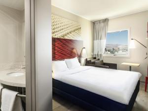 a hotel room with a bed and a sink at ibis Calama in Calama