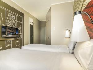a hotel room with two beds and a lamp at ibis Calama in Calama +60 photos