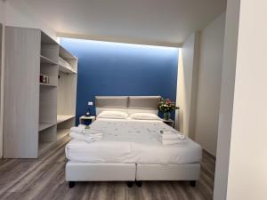 a bedroom with a white bed and a blue wall at Hotel Giardinetto Al Sant'Orsola in Bologna +57 photos