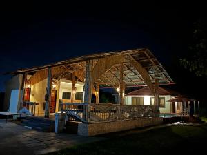a house with a wooden roof at night at Ashaya Agro Farms in Umberpāda