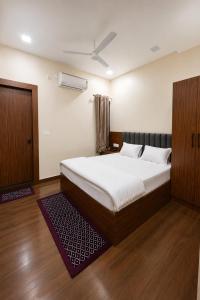 a bedroom with a large bed and a window at Hotel Ram Sadan in Ayodhya