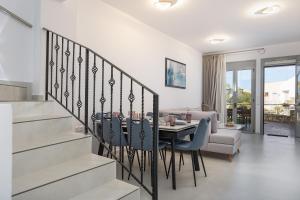 a dining room and living room with a table and chairs at Antonias Serenity in Loutra