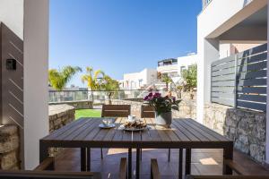 a wooden table on the balcony of a house at Antonias Serenity in Loutra