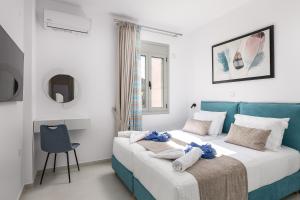 a bedroom with two beds and a chair at Antonias Serenity in Loutra +52 photos