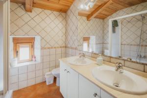a bathroom with two sinks and a toilet at Peña in Castro de Fuentidueña +18 photos