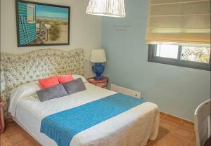 a bedroom with a bed with two pillows on it at Apartamento en Valle del Este in Vera +21 photos